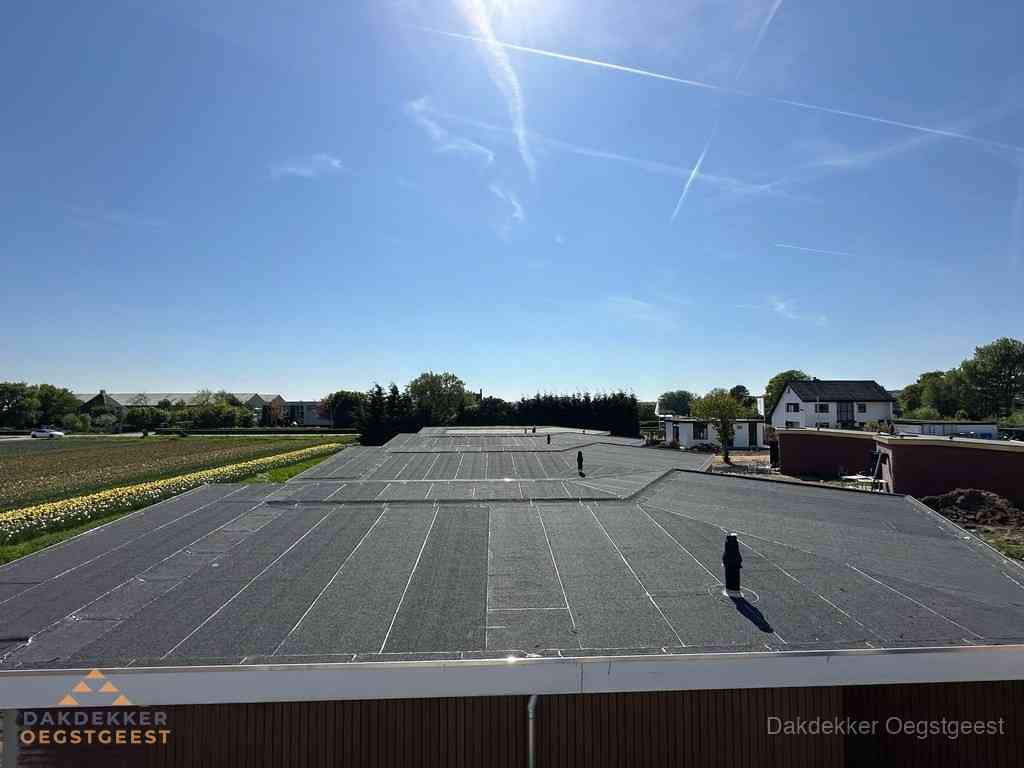 Groot plat dak met bitumen dakbedekking op bedrijfspand in Oegstgeest Groot plat dak met bitumen dakbedekking op bedrijfspand in Oegstgeest